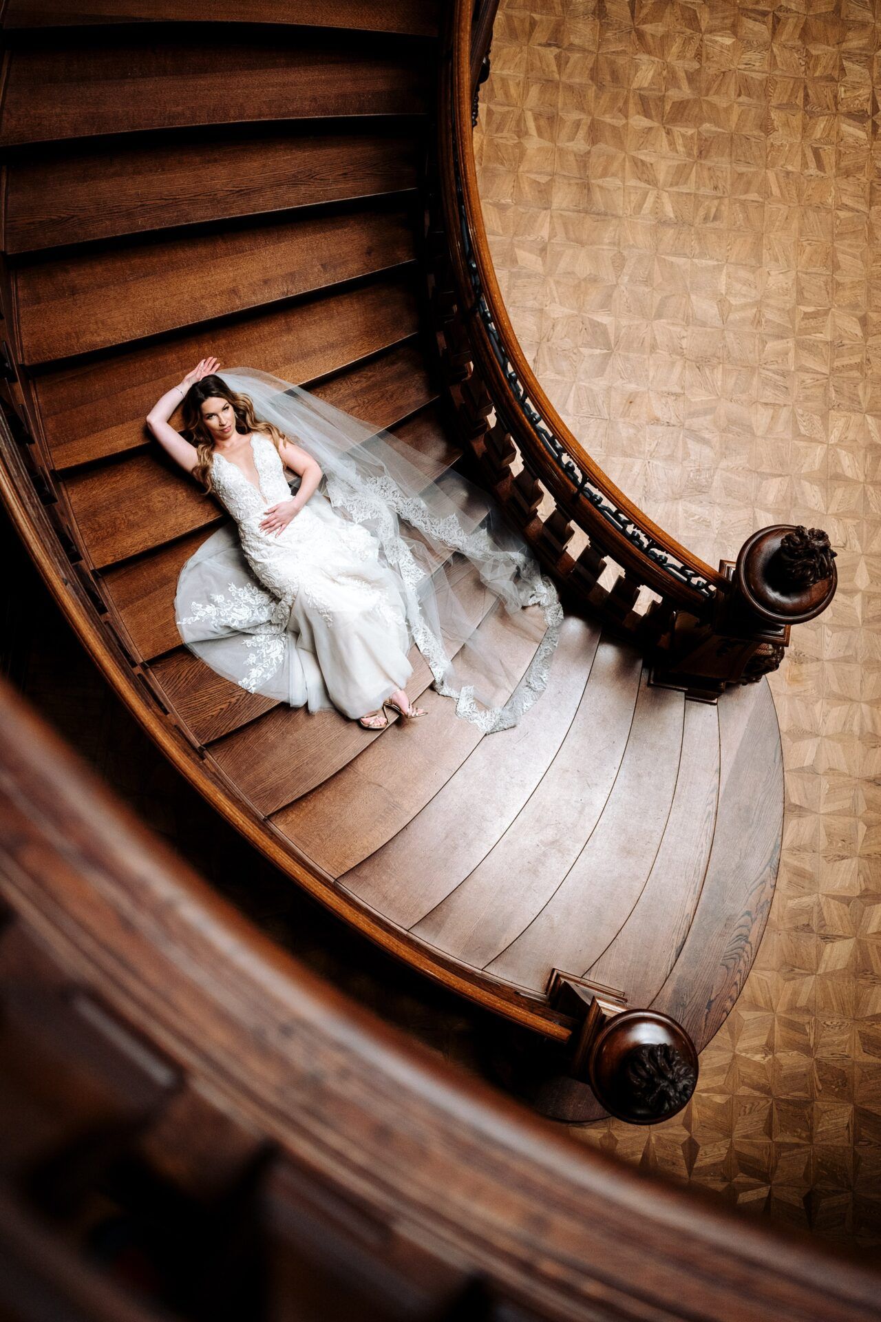 Sesja ślubna w Pałacu Goetz, portret panny młodej leżącej na schodach